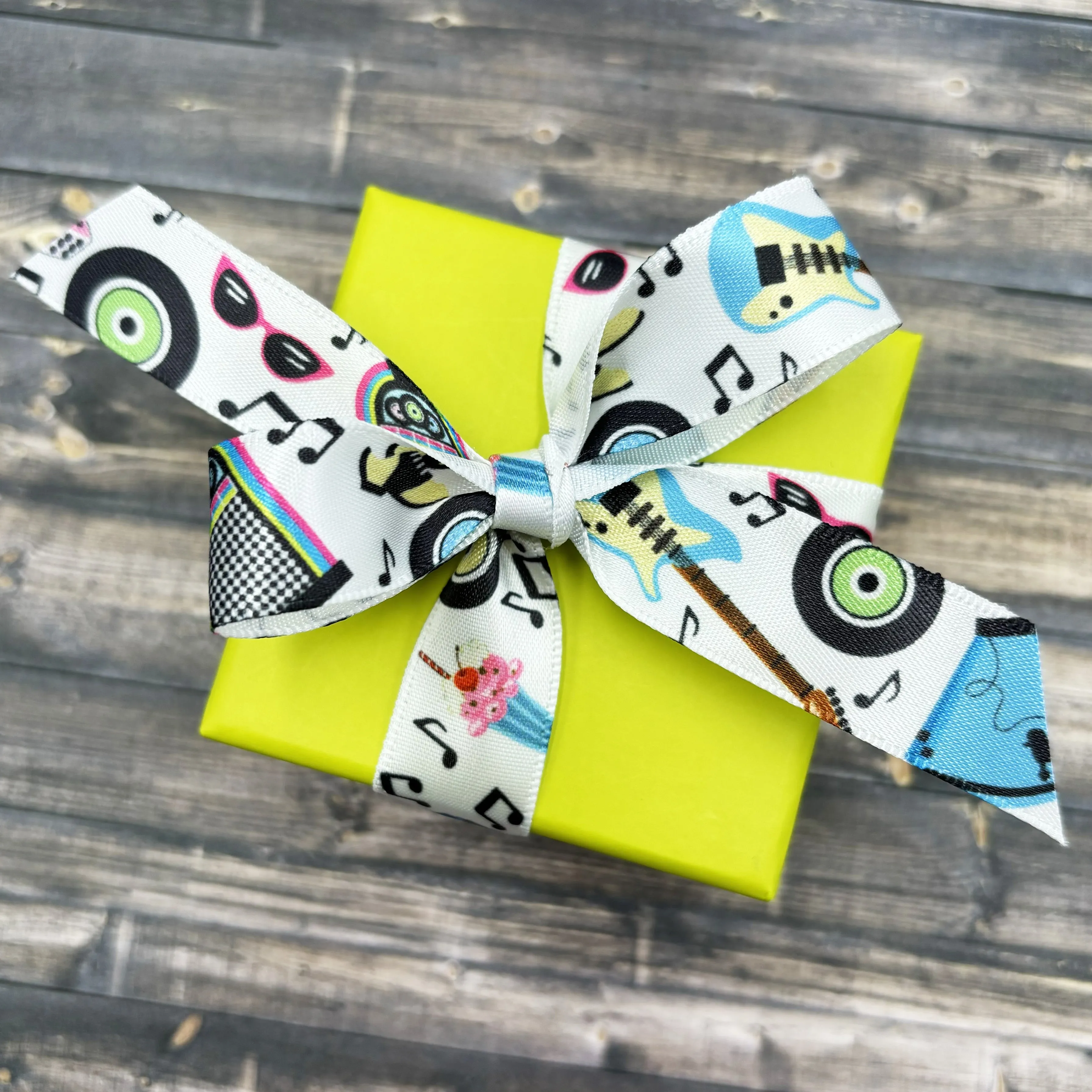 Sock Hop Vintage '50 ribbon featuring poodle skirts, guitars, Juke boxes, musical notes in turquoise, pink and black printed on 5/8" white satin